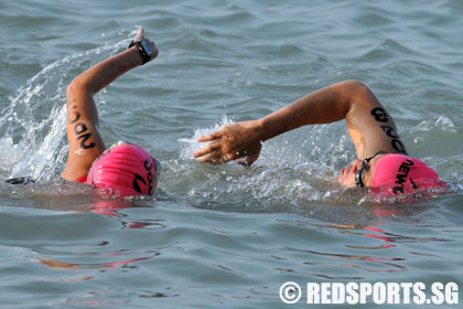 Wong Meng Ee (right) and guide Tan Swee Kheng finish the swim in a ...