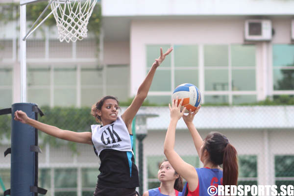 The GK of SP attempting to disrupt the GS of TP while she is taking a shot.