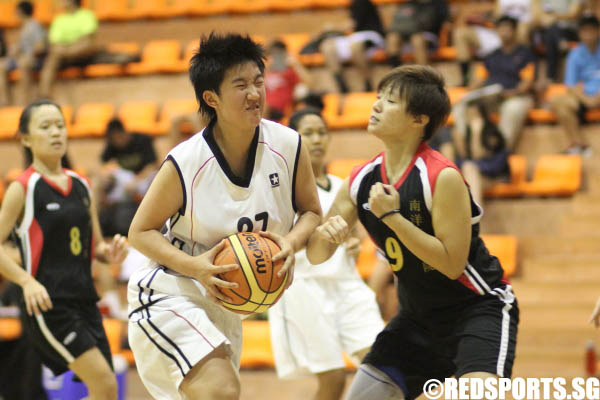 Lim Liying (SMU #27) driving into the paint with Bon Sek Hui (NYP #9) trying to stop her 