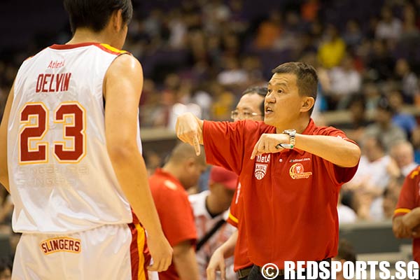 Youngest Slingers player Delvin Goh (#23) gets advice from coach Neo Being Siang in between the game. 