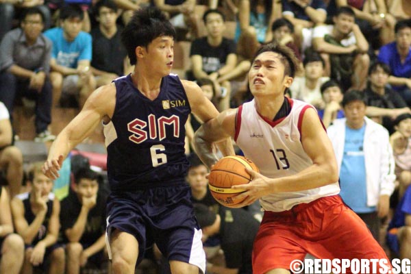 A battle of captains. Yap Ching Poh (NTU #13) tries to drive to the basket with Ron Teh (SIM #6) guarding him closely.