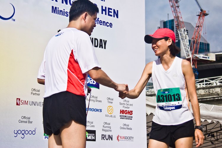 Hui Bing Thio, 1st runner up, 21k Womens Master beams while receiving her medal