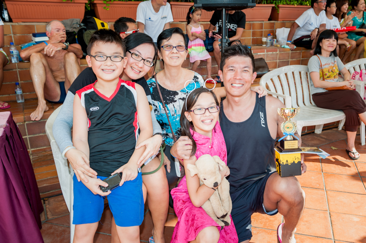 Vincent Koh (right) poses for a photo with his family after his record-setting feat at the Swim For Hope 2013. (Photo 2 courtesy of SAFRA)