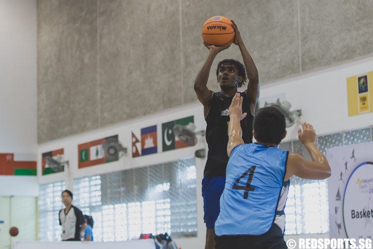 Vignesh Rengarajan of SKC attempting a jump shot during the U-17 boys' 3 x 3 basketball competition of the Singapore Youth Olympic Festival. (Photo 22 © Soh Jun Wei/Red Sports)