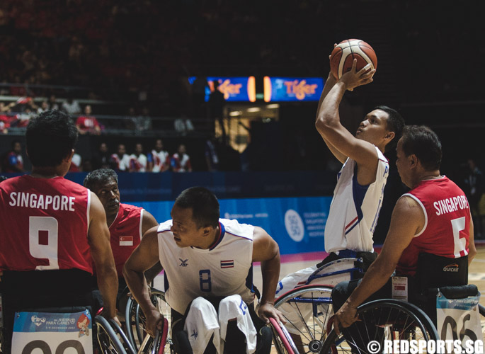 Pongsakorn Sripirom (THA #12) attempts a shot during the wheelchair basketball game at the 8th ASEAN Para Games. (Photo 4 © Soh Jun Wei/Red Sports)