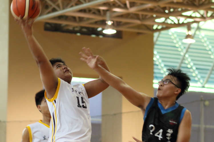 #15 of Tanglin attempting a layup over Hein Htet Aung (Fajar #24).