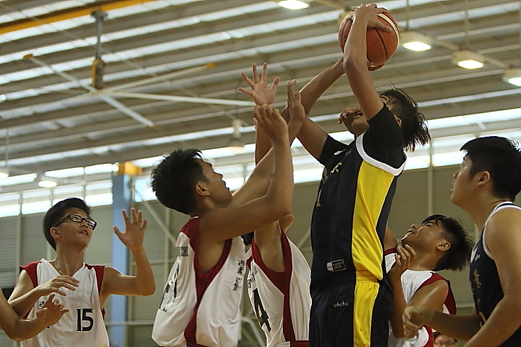 A Northland player attemting to make a shot while heavily guarded by 3 defenders.