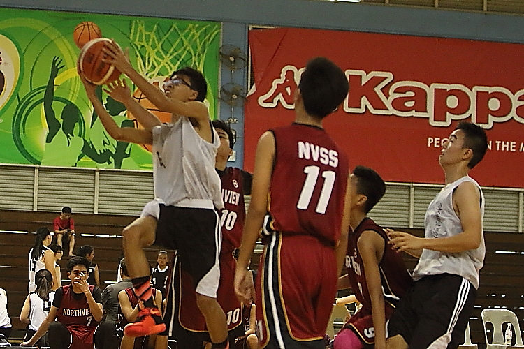 Anderson's Imram B Azman(White #4) soaring for a layup in traffic.