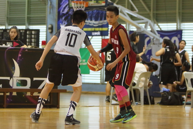 North View's #9(Red) looks to drive past Anderson's Ng Zhen Xuan(White #10). North View's #9 led his team in scoring with 14 points. 