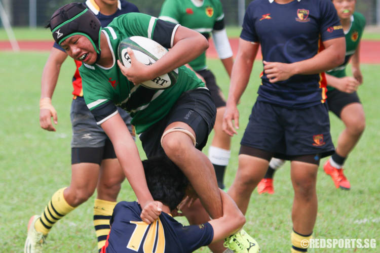 Sek Ray (RI #26) grabs Tristan [ACS(BR) #10], who attempts to tackle him. (Photo 11 © REDintern Chua Kai Yun)