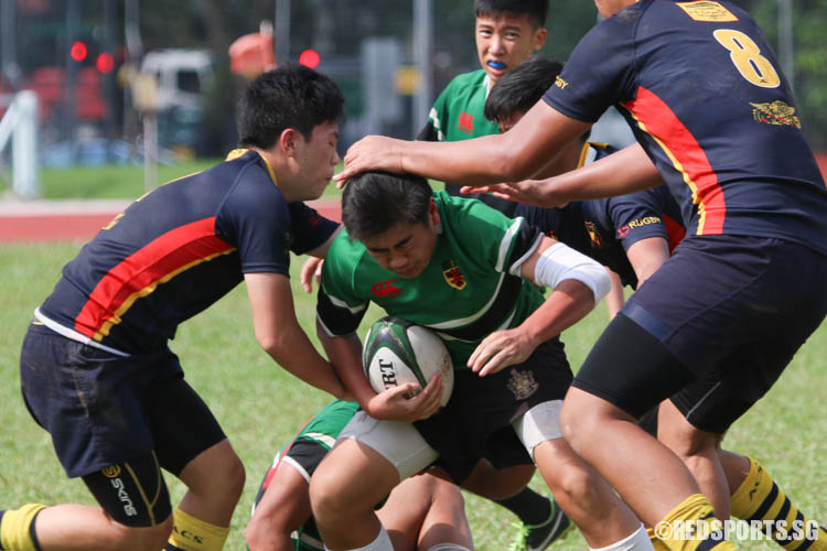 ACS(BR) players tackle Bervyn Wong (RI #24). (Photo 6 © REDintern Chua Kai Yun)