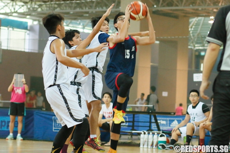 Delvin Low (ZH #15) attempts a layup while triple-teamed by the Kranji defense. He had 8 points in the game. (Photo  © Chan Hua Zheng/Red Sports)