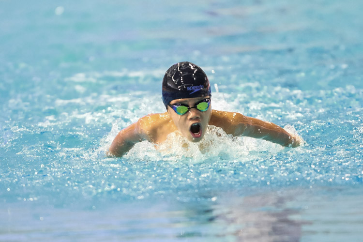 Lachlan Goh swims during the boys' 8-12 year old 100m butterfly. He finished third with a timing of 1:17.22. (Photo © Soh Jun Wei/Red Sports)