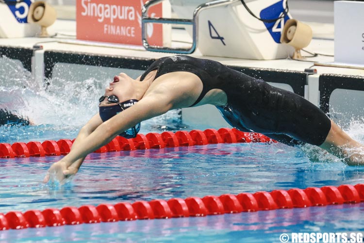 Anna Pang diving into the pool to start her 50m backstroke 15 and over 'A' finals at the Singapore National Age Group Swimming Championships. She finished second among 15-17 year olds with a timing of 29.89s, setting a new meet record. (Photo © Soh Jun Wei/Red Sports)