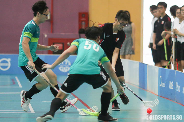 A NJC player dribbles the ball under pressure from TJC. (Photo © Chua Kai Yun/Red Sports)