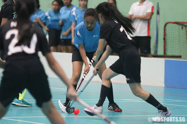 Noor Hadaina Bte Ibrahim (MI #2) controls the ball under pressure from a NYJC player. (Photo © Chua Kai Yun/Red Sports)