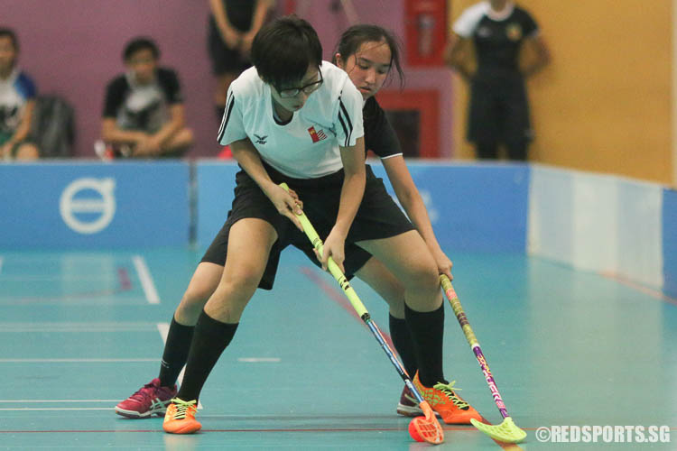 Marie Lim (NJC #2) prevents RJC from getting the ball. (Photo © Chua Kai Yun/Red Sports)