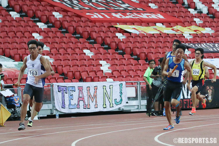 Trahern Low (#163, SAJC) and Alphonsus Teow (#71, CJC) running the third leg of the A Division Boys 4x100m relay final.  (Photo © Chua Kai Yun/Red Sports)