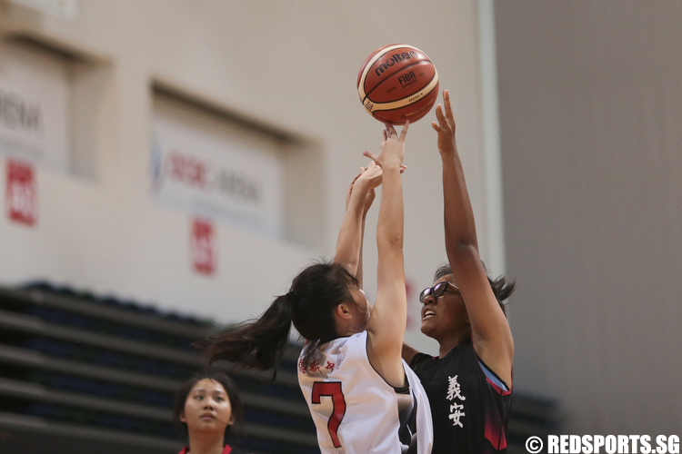 (#16) of Ngee Ann Secondary shoots against Lydia Ang (#7) of North Vista Secondary. (Photo © Lee Jian Wei/Red Sports)