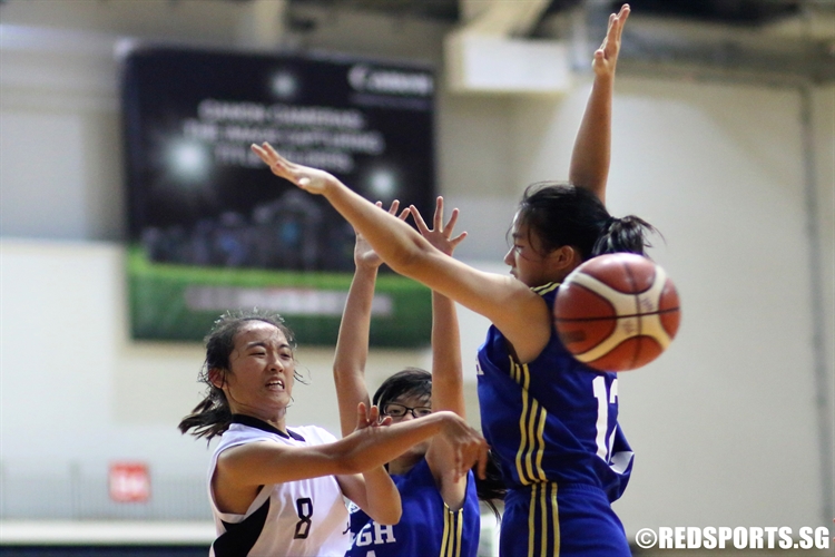 Lin Ying Xin (CCHMS #8) draws two defenders and kicks the ball to an open teammate. (Photo 4 © Dylan Chua/Red Sports)