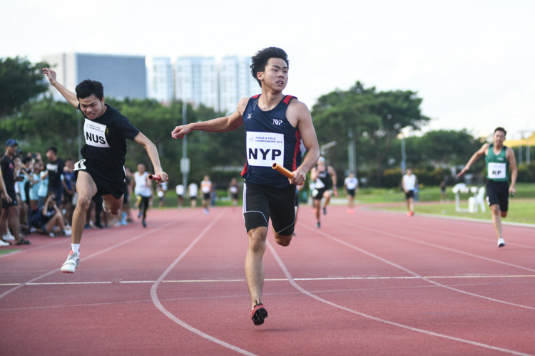 Joshua Chua of Nanyang Polytechnic crossing the finish line second in the 4x100m Men's Relay, but a botched baton handover in the first exchange zone meant his team got disqualified. (Photo 8 © Stefanus Ian/Red Sports)