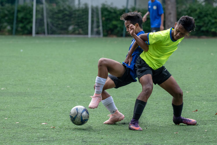 CCKSS captain Adib Hilmy (#17, in blue) fights JVSS player Mhd Izwan (#10, in green) for possession.