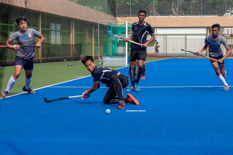 Haw Jia Jun Bryan (SKS #24) clears the ball before St Hilda players are able to get close. (Photo 8 © REDintern Jordan Lim)