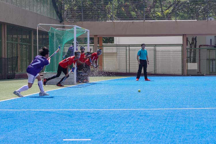 Loh Kuan Meng, Darius (SAS #7) passes the ball from a penalty corner, with Sengkang players tightly defending their goal. (Photo 2 © REDintern Jordan Lim)