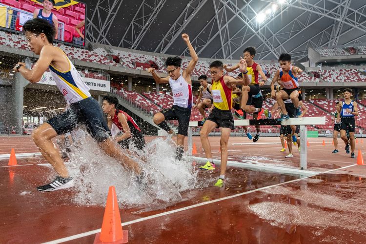 The B Division boys at the water jump of the 2000m steeplechase final.