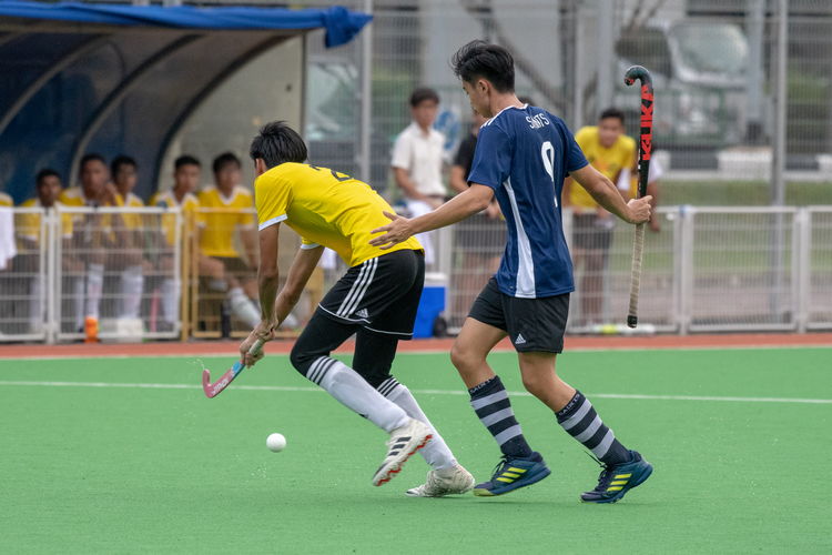 Ray Au (#9) of SAJC raises his hands in exasperation after losing the ball to a VJC player.