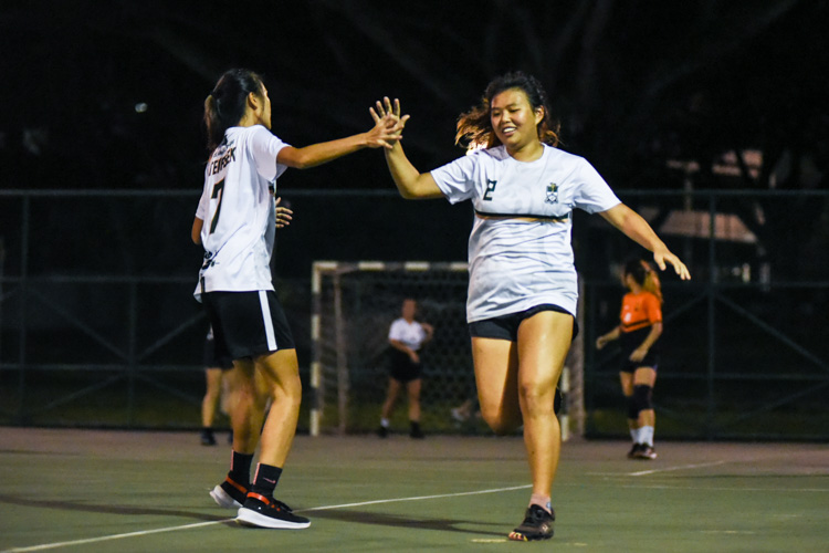 Temasek Hall's Arielle Chiang (#2) and Selina Ang (#7) celebrate a goal during the Women's IHG Handball final against Sheares Hall. (Photo 1 © Iman Hashim/Red Sports)