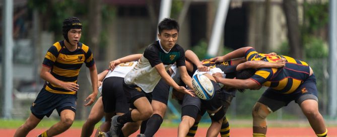 Raffles Institution's Keane Yeo (centre) passes the ball off a heavily contested scrum. Anglo-Chinese School (Independent) Sub Team 2 bested Raffles Institution Sub Team 2 with a score of 33-0 in the 2022 National School Games Rugby B Division first Cup semi final.