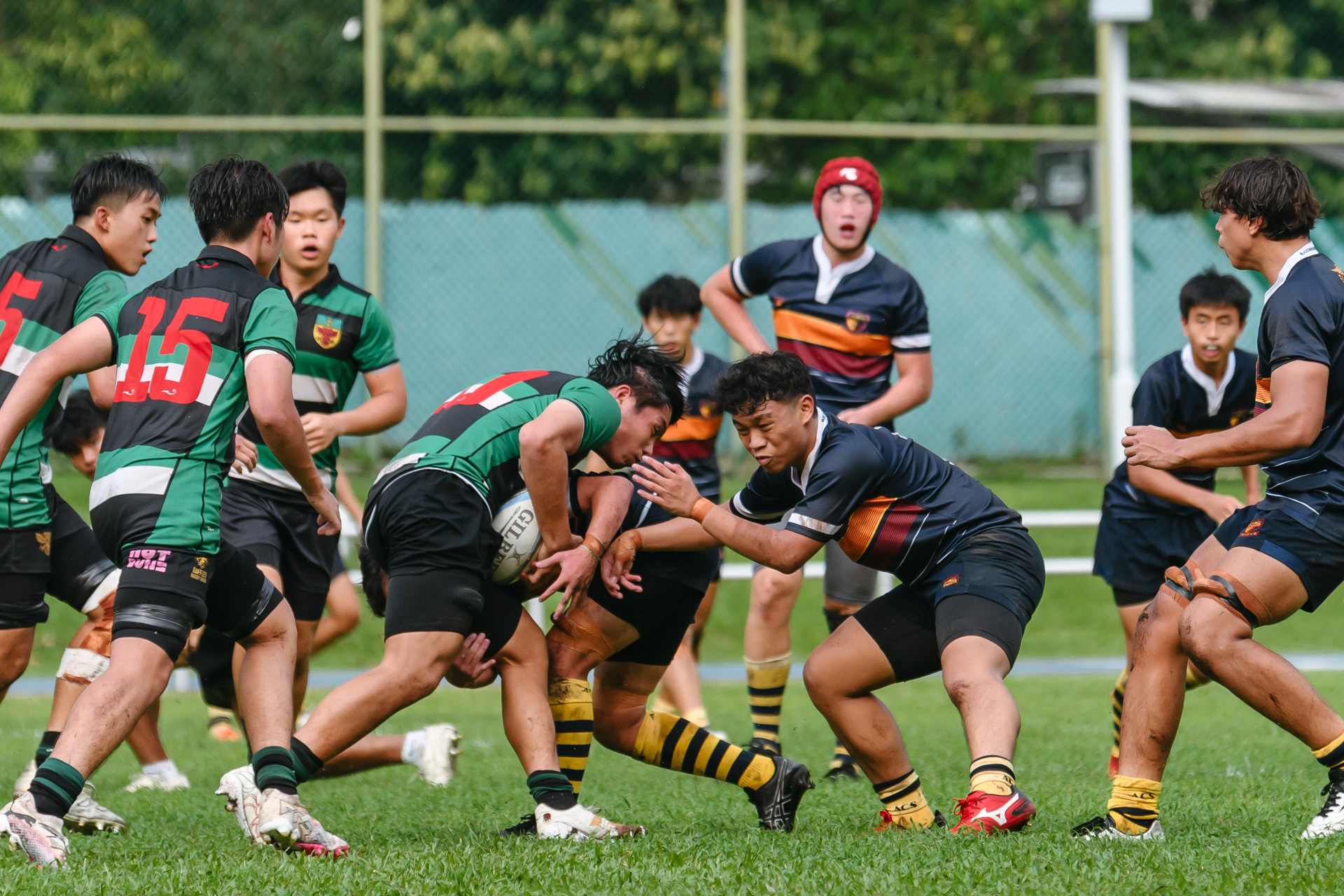 ACJC’s Gareth Seah (#02) braces for a tackle. (Photo 9 © Jared Chow/Red Sports)